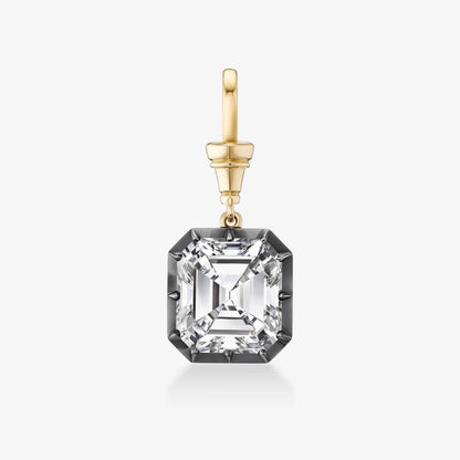 A single drop earring featuring a large, clear, emerald-cut gemstone in a darkened silver or blackened gold setting, suspended from a polished yellow gold bail, shown on a light gray background.