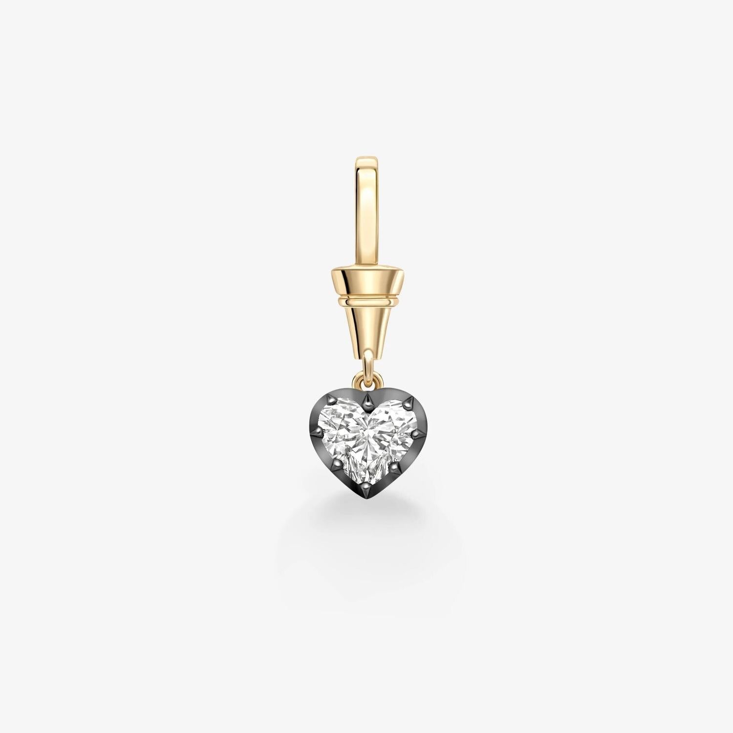 Gold pendant with a central gemstone on a white background
