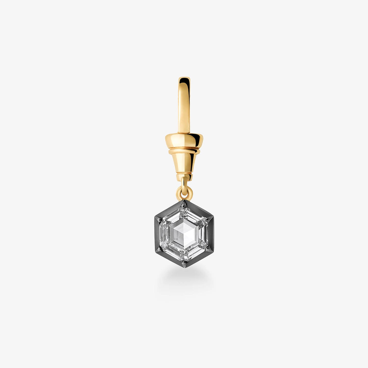A single geometric drop earring featuring a clear faceted gemstone in a silver-toned hexagonal setting, suspended from a polished gold-toned top post, on a light gray background.