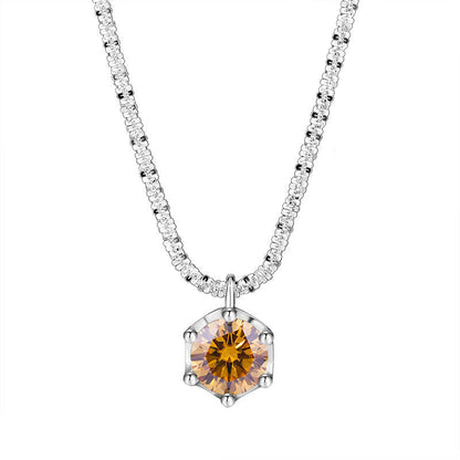A silver-toned necklace featuring a hexagonal pendant with a faceted amber-orange center stone and clear surrounding stones on a white background, with the brand name NORELLE in the bottom left corner.