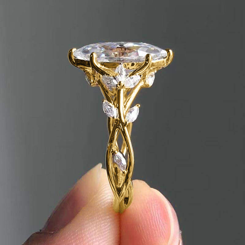 Gold ring with a large central diamond and smaller diamonds on a gray background