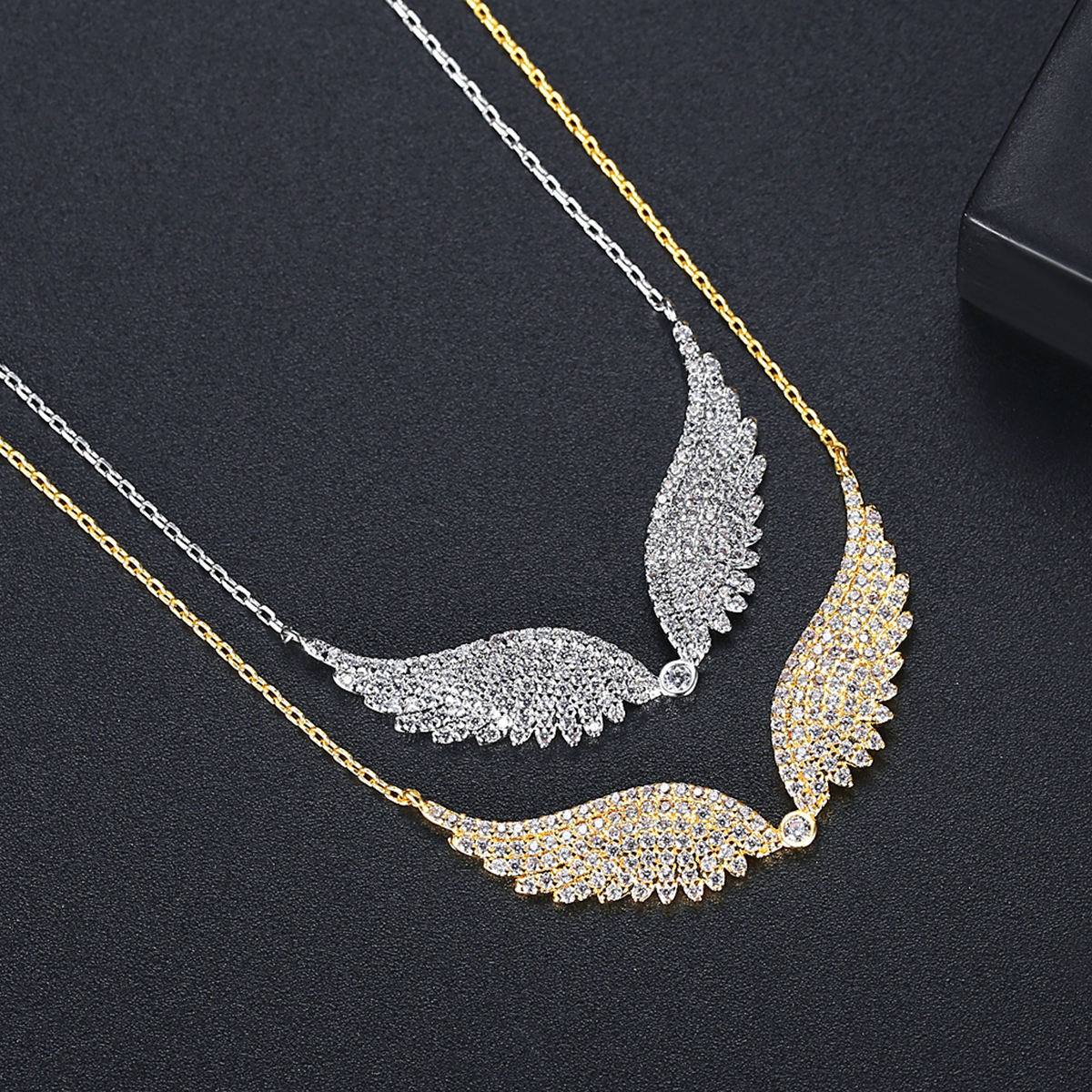 Necklace with leaf-like design in gold and silver on a dark background
