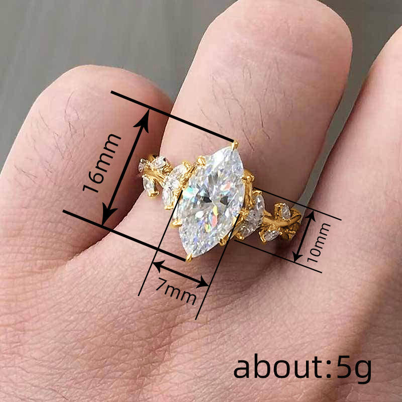 Gold ring with a large diamond on a finger, showing measurements.