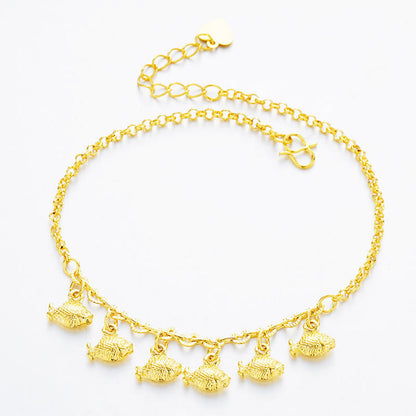 A gold chain anklet featuring five textured fish charms dangling from the front, displayed on a clean white background.