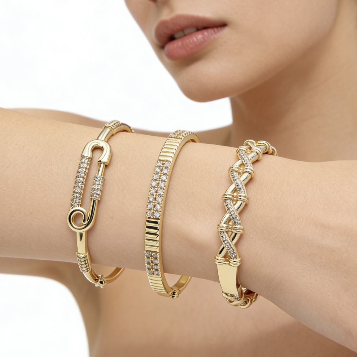 Woman wearing Dzebonde gold crystal bangle bracelets showcasing elegant everyday luxury jewelry.